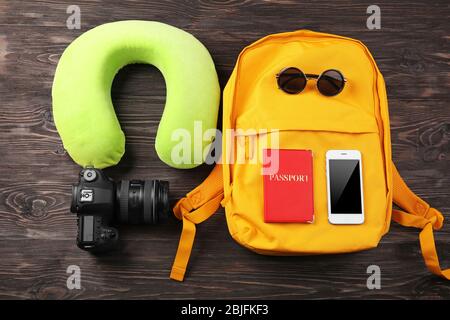 Travel pillow and things for traveling on wooden background Stock Photo