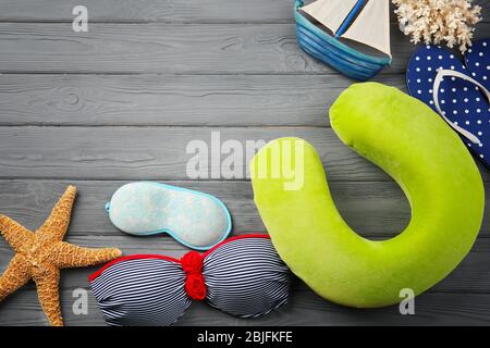 Travel pillow and things for traveling on wooden background Stock Photo