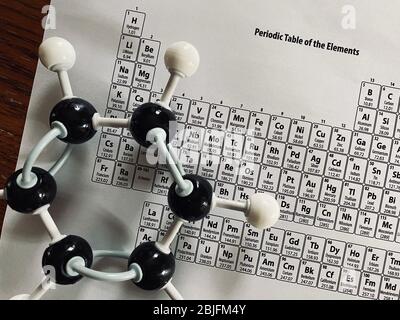 Molecular model of Benzene (C6H6) with a copy of the Periodic Table of Elements Stock Photo