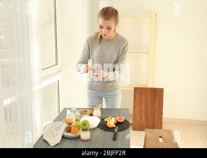 Young woman photographing food with smart phone Stock Photo