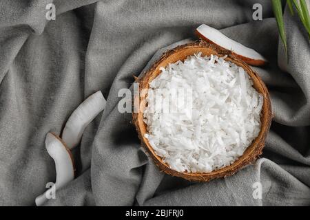 Grated coconut in shell on table Stock Photo