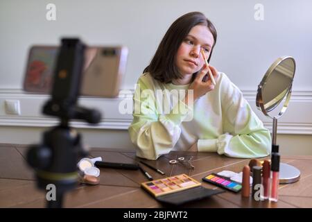 Teenage girl, beauty blogger filming video for channel blog, eyeshadow painting Stock Photo