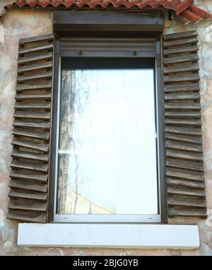 Plastic window with vintage shutters Stock Photo