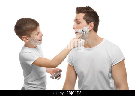 Father and son shaving on white background Stock Photo