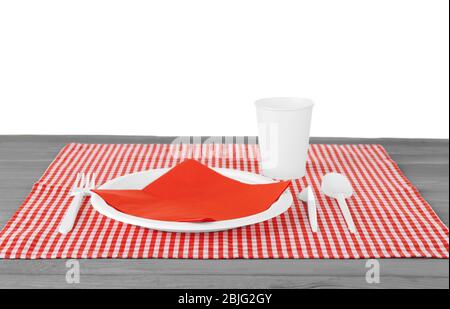 White plastic disposable tableware on wooden table Stock Photo