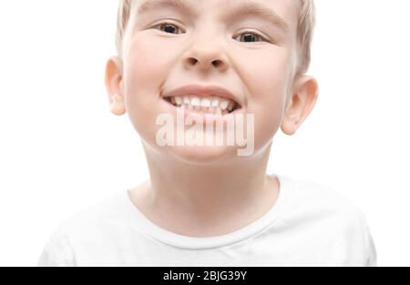 Cute little boy showing teeth on white background, close up Stock Photo