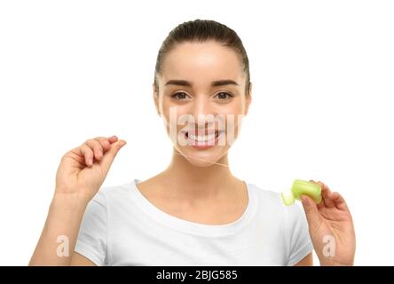 Young beautiful woman using dental floss on white background. Oral hygiene concept Stock Photo