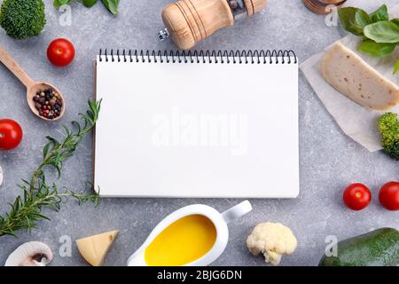 Cheese sauce with ingredients and blank notebook on light background Stock Photo