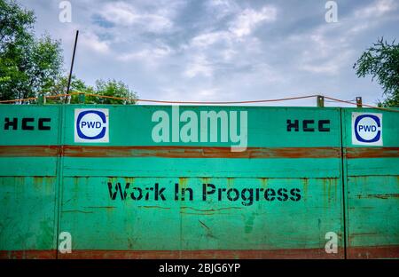 Delhi / India - September 22, 2019: Work in progress sign in New Delhi, India. Hindustan Construction Company (HCC) contracted by the Public Works Dep Stock Photo