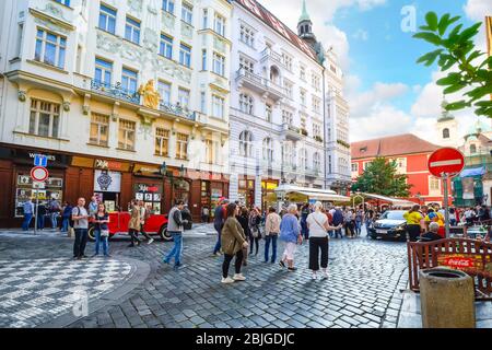 A busy street in Old Town Prague with tourists and locals window shopping and enjoying the medieval center of the city. Stock Photo