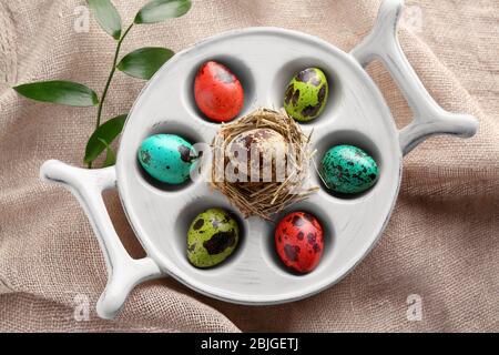 Easter eggs in stand on sackcloth Stock Photo