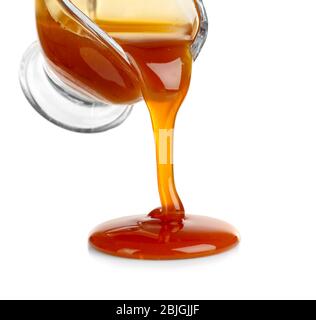 Pouring caramel sauce onto white background Stock Photo