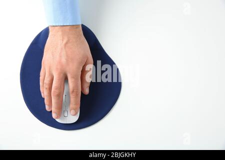 Male hand with computer mouse and pad on white background Stock Photo