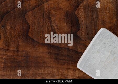 an amphora and some seashells on a rough wooden texture grunge sea washed weathered wood and colorful sea urchin shells top view, filtered image with Stock Photo