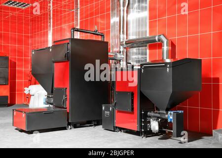 Different solid fuel boilers in room. Energy savings concept Stock Photo