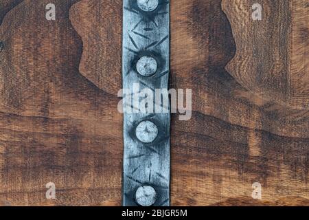 punched medieval belt on a wood background with space for text background with space for text Stock Photo