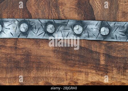 punched medieval belt on a wood background with space for text background with space for text Stock Photo