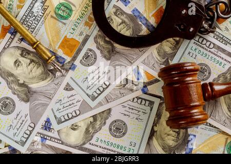 Justice and law concept cash dollars in banknotes judge gavel with handcuffs in court Stock Photo