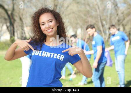 Beautiful African American volunteer outdoors Stock Photo