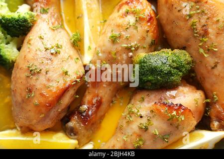 Delicious chicken legs with lemon, closeup Stock Photo