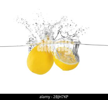 Fresh lemons in water on white background Stock Photo