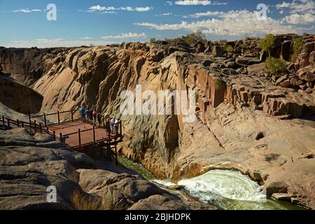 Tourists on viewing platform looking at Augrabies Falls on Orange River, Augrabies Falls National Park, Northern Cape, South Africa Stock Photo