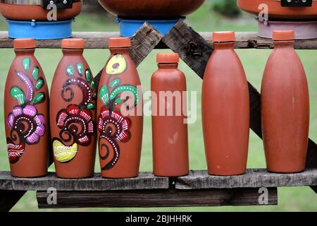 clay brown water bottle tied by a ribbon is isolated on the white background. Stock Photo