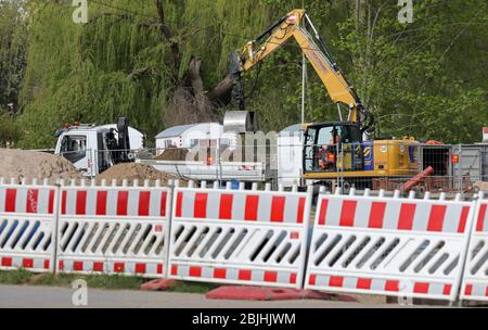 Rostock, Germany. 28th Apr, 2020. A site fence secures a construction site for the preparatory work for a new residential area. The latest unemployment figures will be published on 30.04.2020. Credit: Bernd Wüstneck/dpa-Zentralbild/ZB/dpa/Alamy Live News Stock Photo
