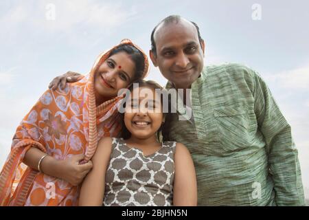 indian Parents with daughter standing low angle view Stock Photo