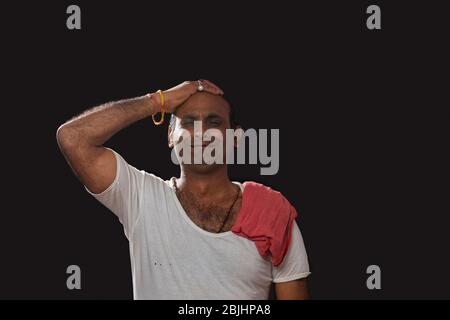 Depressed Indian farmer standing and holding his head in disbelief ...