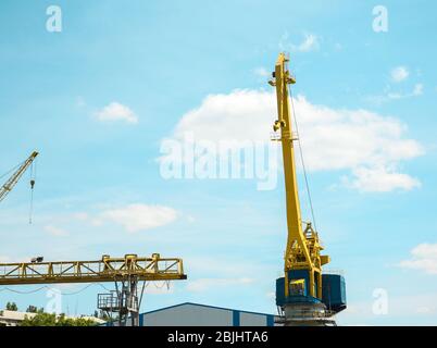 Hoisting cranes in dockyard Stock Photo