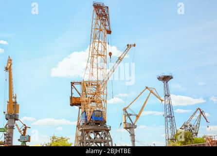 Hoisting cranes in shipyard Stock Photo