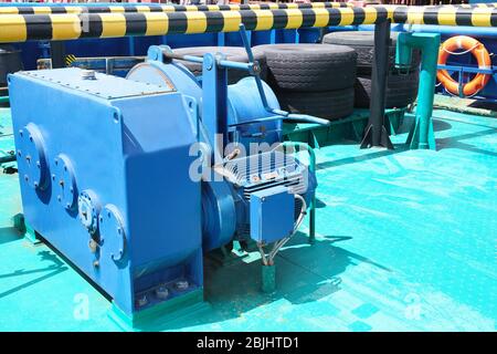 Anchor windlass on ship deck in sunny day Stock Photo