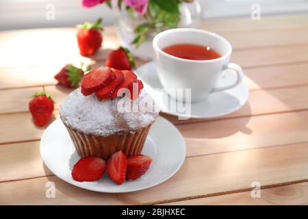 Delicious muffin and cup of tea on windowsill Stock Photo