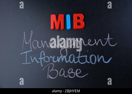 Phrase MANAGEMENT INFORMATION BASE written on blackboard. Management concept Stock Photo