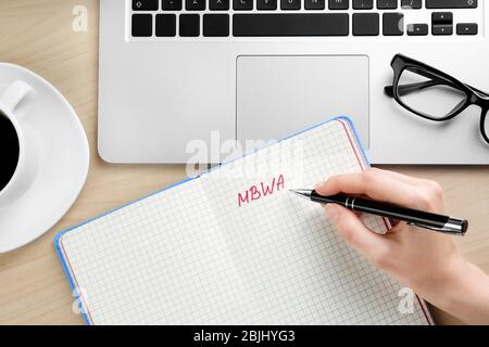 Female hand writing text in notebook. Management concept Stock Photo
