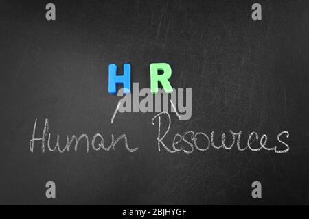 Phrase HUMAN RESOURCES written on blackboard. Management concept Stock Photo