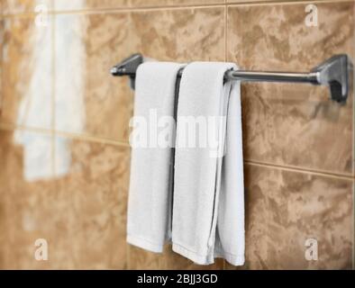 Dryer with soft towels in bathroom Stock Photo
