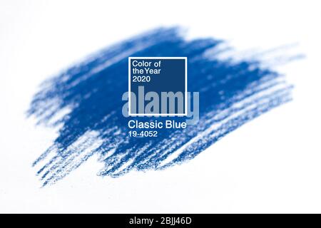 Classic Blue. Color of the Year 2020. Brush stroke of blue paint on white paper. Stock Photo