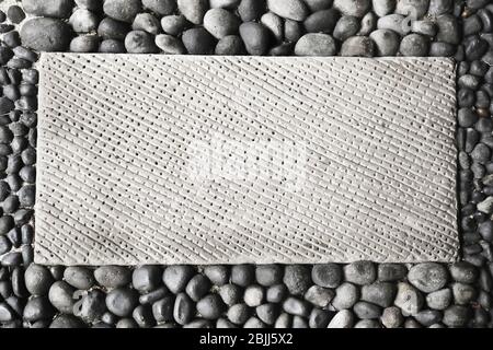 Frame made of concrete plate and smooth pebbles Stock Photo