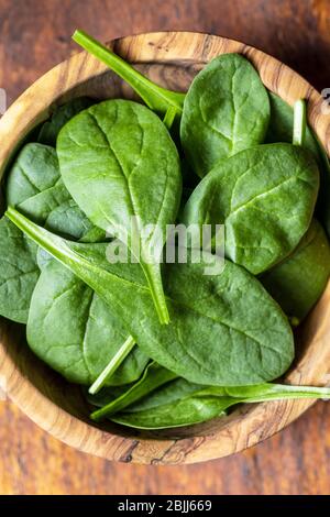 Baby spinach leaves. Green spinach in bowl. Top view. Stock Photo