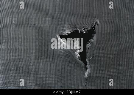 Torn window screen, closeup Stock Photo