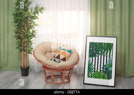 Framed Picture Of Tropical Leaves And Papasan Chair Indoors Stock Photo Alamy