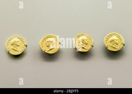 Merida, Spain - August 25th, 2018: Gold Roman Imperial coins bearing the bust of Emperor Vespasian. National Museum of Roman Art in Merida, Spain Stock Photo