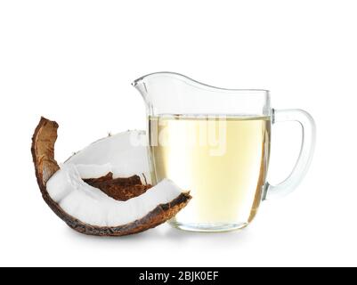 Ripe coconut and pitcher with oil isolated on white Stock Photo