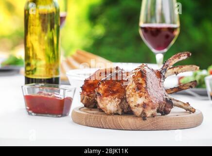 Delicious ribs with wine served for dinner on table Stock Photo