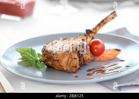 Plate with delicious rib and vegetables on table, close up Stock Photo