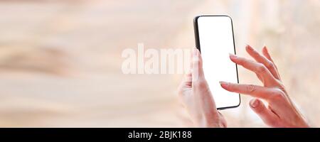 Female hand with smartphone, white blank screen with copy space. Stock Photo