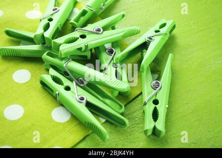 Green clothes pins on color table Stock Photo