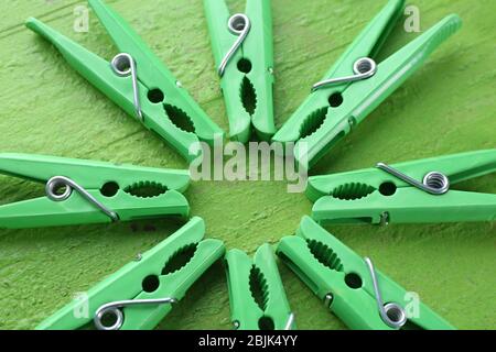 Green clothes pins on color table Stock Photo